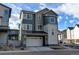 Two-story modern home with attached garage and light-grey siding at 11728 Octave Ave, Lone Tree, CO 80134