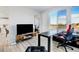 Modern home office with a desk, chair, and large window at 11728 Octave Ave, Lone Tree, CO 80134