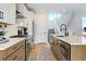 Modern kitchen with white and wood cabinets, and a large island at 11728 Octave Ave, Lone Tree, CO 80134