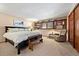 Comfortable bedroom with a king-size bed and built-in shelving at 1228 Pomegranate Ln, Golden, CO 80401