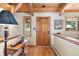 Bright entryway with hardwood floors, a wooden console table, and an interior door at 1228 Pomegranate Ln, Golden, CO 80401