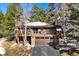 Mountain home exterior with a two-car garage and balcony at 1228 Pomegranate Ln, Golden, CO 80401