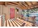 Charming front porch with wooden chairs and a red front door at 1228 Pomegranate Ln, Golden, CO 80401