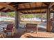 Covered porch with wooden seating offering views of a snow-covered landscape at 1228 Pomegranate Ln, Golden, CO 80401