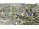Birds-eye view of the property featuring a stone patio, lush lawn, and mature trees at 19336 Queens Crescent Way, Monument, CO 80132