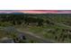 Majestic aerial view of a stunning home nestled among trees, showcasing breathtaking mountain views at sunset at 19336 Queens Crescent Way, Monument, CO 80132