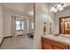 View from the bedroom toward the bathroom with a wooden vanity and bright lighting at 19336 Queens Crescent Way, Monument, CO 80132