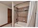 Bathroom with a white shower curtain, shower, and brown tile at 19336 Queens Crescent Way, Monument, CO 80132