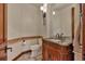 Elegant half bathroom with ornate vanity, stylish fixtures, and decorative tile accents, for a touch of luxury at 19336 Queens Crescent Way, Monument, CO 80132