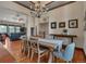 Elegant dining room with hardwood floors, chandelier, and views into the living room at 19336 Queens Crescent Way, Monument, CO 80132