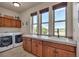 Bright laundry room with a sink, ample cabinet space, and large windows overlooking scenic views at 19336 Queens Crescent Way, Monument, CO 80132