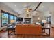 Inviting living room with a stone fireplace, hardwood floors, and beamed ceilings at 19336 Queens Crescent Way, Monument, CO 80132