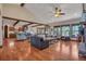Open-concept living area featuring a kitchen island, stone fireplace, and lots of natural light at 19336 Queens Crescent Way, Monument, CO 80132