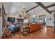 Cozy living room with hardwood floors, stone fireplace, wood beams, and an open floor plan at 19336 Queens Crescent Way, Monument, CO 80132