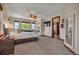 Bright main bedroom featuring a fireplace, ceiling fan, and large windows for natural light and scenic views at 19336 Queens Crescent Way, Monument, CO 80132