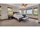 Main bedroom features multiple windows with views, neutral carpet, and wood trim at 19336 Queens Crescent Way, Monument, CO 80132