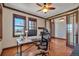 Bright office featuring hardwood floors, natural wood trim, windows, and a ceiling fan at 19336 Queens Crescent Way, Monument, CO 80132
