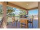 Covered patio with wood decking, outdoor furniture, grill, and picturesque views of the surrounding landscape at 19336 Queens Crescent Way, Monument, CO 80132