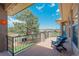 Covered patio with wood decking, railings, chairs, and stunning views of the yard and beyond at 19336 Queens Crescent Way, Monument, CO 80132