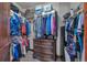 Spacious walk-in closet with custom shelving and hanging rods, providing plentiful storage for clothing and accessories at 19336 Queens Crescent Way, Monument, CO 80132