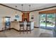 Charming wet bar with barstool seating, custom cabinetry, and sliding door access to the yard at 19336 Queens Crescent Way, Monument, CO 80132