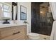Bathroom featuring black marble tiled shower, new vanity, and modern finishes at 6087 W 84Th Ave, Arvada, CO 80003