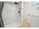 Modern bathroom featuring a tiled shower with black fixtures and a sleek white vanity at 6087 W 84Th Ave, Arvada, CO 80003