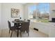 Bright breakfast nook with gray upholstered chairs, hardwood floors, and picture window with an outdoor view at 6087 W 84Th Ave, Arvada, CO 80003