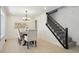 Dining room with modern light fixture, access to stairs and neutral decor at 6087 W 84Th Ave, Arvada, CO 80003