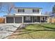 Charming two-story home with fresh exterior paint, an inviting front porch and green lawn at 6087 W 84Th Ave, Arvada, CO 80003