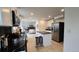 Modern kitchen featuring white cabinets, dark granite countertops, and stainless steel appliances at 6087 W 84Th Ave, Arvada, CO 80003