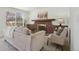 Cozy living room with a brick fireplace, neutral decor, and lots of light at 6087 W 84Th Ave, Arvada, CO 80003