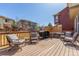Inviting back deck featuring comfortable seating, a grill, and a hot tub, perfect for outdoor relaxation at 10438 Olathe Way, Commerce City, CO 80022