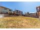Large backyard with a wood fence, offering plenty of space for outdoor activities at 10438 Olathe Way, Commerce City, CO 80022