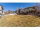 Expansive backyard with grass and a wooden fence, offering ample space and privacy at 10438 Olathe Way, Commerce City, CO 80022