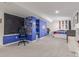 Spacious finished basement area with large chalkboard wall, shelving, and a comfortable gaming chair at 10438 Olathe Way, Commerce City, CO 80022