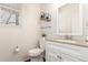 Well-lit half bathroom featuring a modern vanity, granite countertop, and neutral decor for a clean, updated look at 10438 Olathe Way, Commerce City, CO 80022