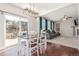 Open dining area featuring hardwood floors, stylish lighting, and backyard access at 10438 Olathe Way, Commerce City, CO 80022