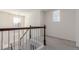 A bright upstairs hallway features neutral carpet and railings with pendant light fixture at 10438 Olathe Way, Commerce City, CO 80022