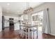 Bright eat-in kitchen featuring white cabinets, stainless steel appliances, and a sliding door to the deck at 10438 Olathe Way, Commerce City, CO 80022