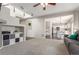 Open-concept living area showcases modern design, integrated shelving, and seamless access to the kitchen at 10438 Olathe Way, Commerce City, CO 80022