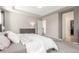 Serene main bedroom with plush carpet, neutral tones, and en suite access at 10438 Olathe Way, Commerce City, CO 80022