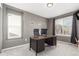 Home office boasts neutral colored walls, large windows, and carpeted flooring at 10438 Olathe Way, Commerce City, CO 80022