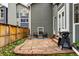 Backyard patio with stone pavers, a grill, outdoor seating, and a view of the fenced yard and neighboring house at 3105 Galileo Ln, Boulder, CO 80301
