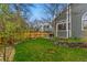 Spacious, fenced backyard with lush green grass, garden bed, a grill, and mature trees at 3105 Galileo Ln, Boulder, CO 80301