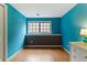 Nicely painted bedroom featuring wood floors, a window with gray trim and a stylish color scheme at 3105 Galileo Ln, Boulder, CO 80301
