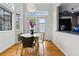 A cozy dining area with hardwood floors, modern lighting, and a table with seating for four, adjacent to the kitchen counter at 3105 Galileo Ln, Boulder, CO 80301