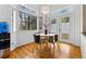 Bright dining area featuring hardwood floors, modern lighting, and a table with seating for four near a window and door to the outside at 3105 Galileo Ln, Boulder, CO 80301