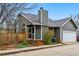 Charming gray home with a manicured front yard, wooden fence, and an attached one car garage at 3105 Galileo Ln, Boulder, CO 80301