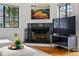 Close up of the living room fireplace with a black tile surround and mounted television at 3105 Galileo Ln, Boulder, CO 80301